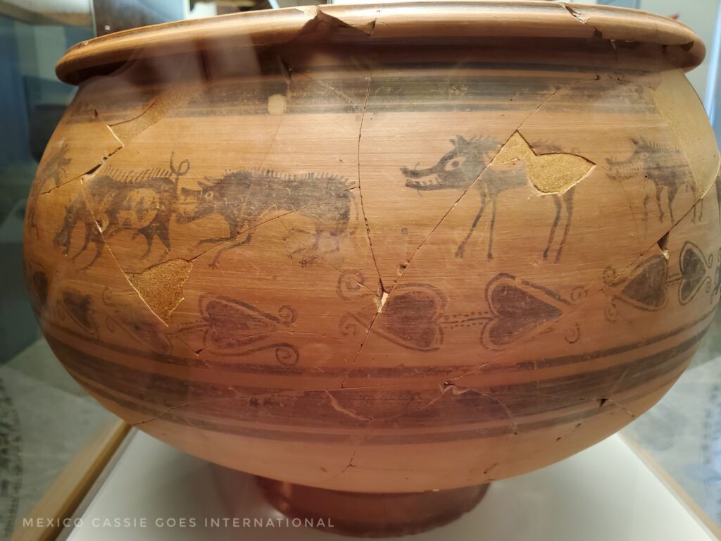 ancient pot decorated with pictures of a hunt