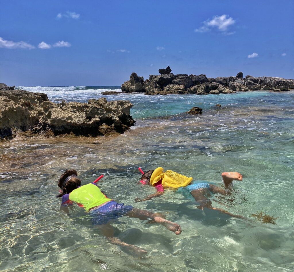 2 kids snorkeling in shallow water