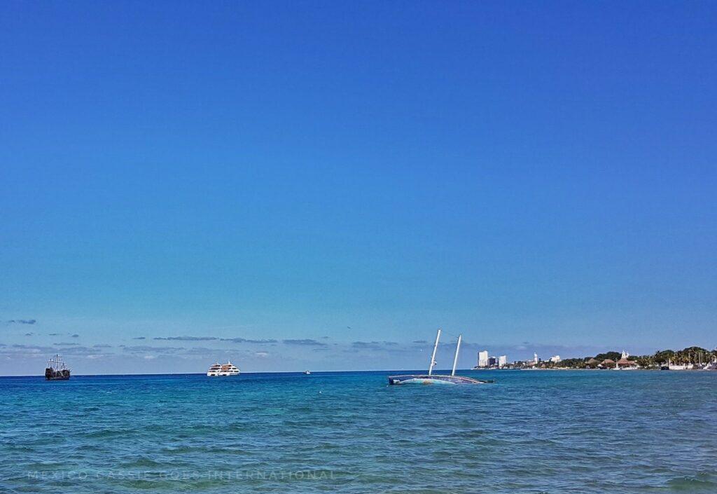 blue sea and blue sky, pirate boat and half submerged tourist submarine visible