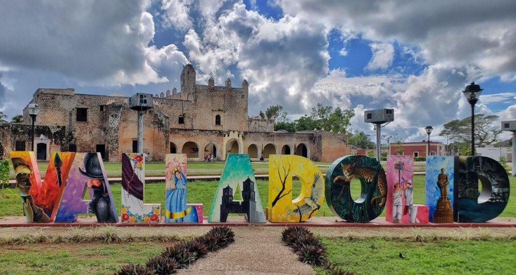 Colourful, large Valladolid letters with ex convent San Bernardino de Siena behind