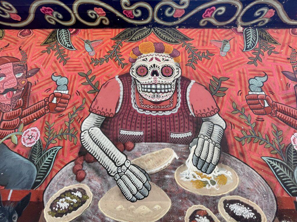 wall art - a fat catrina in clothing making tacos. red background