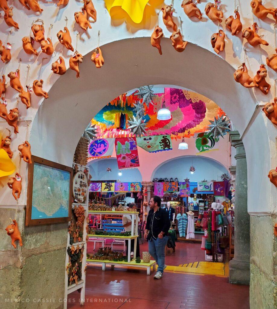 view through an arch into a shop selling souvenirs