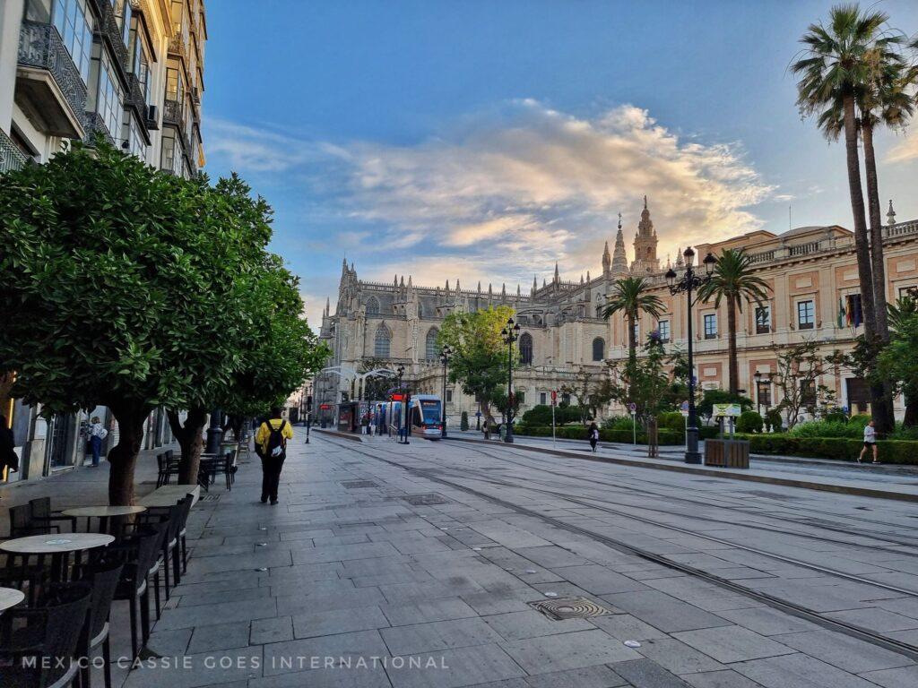 Seville - nearly empty street, dawn clouds