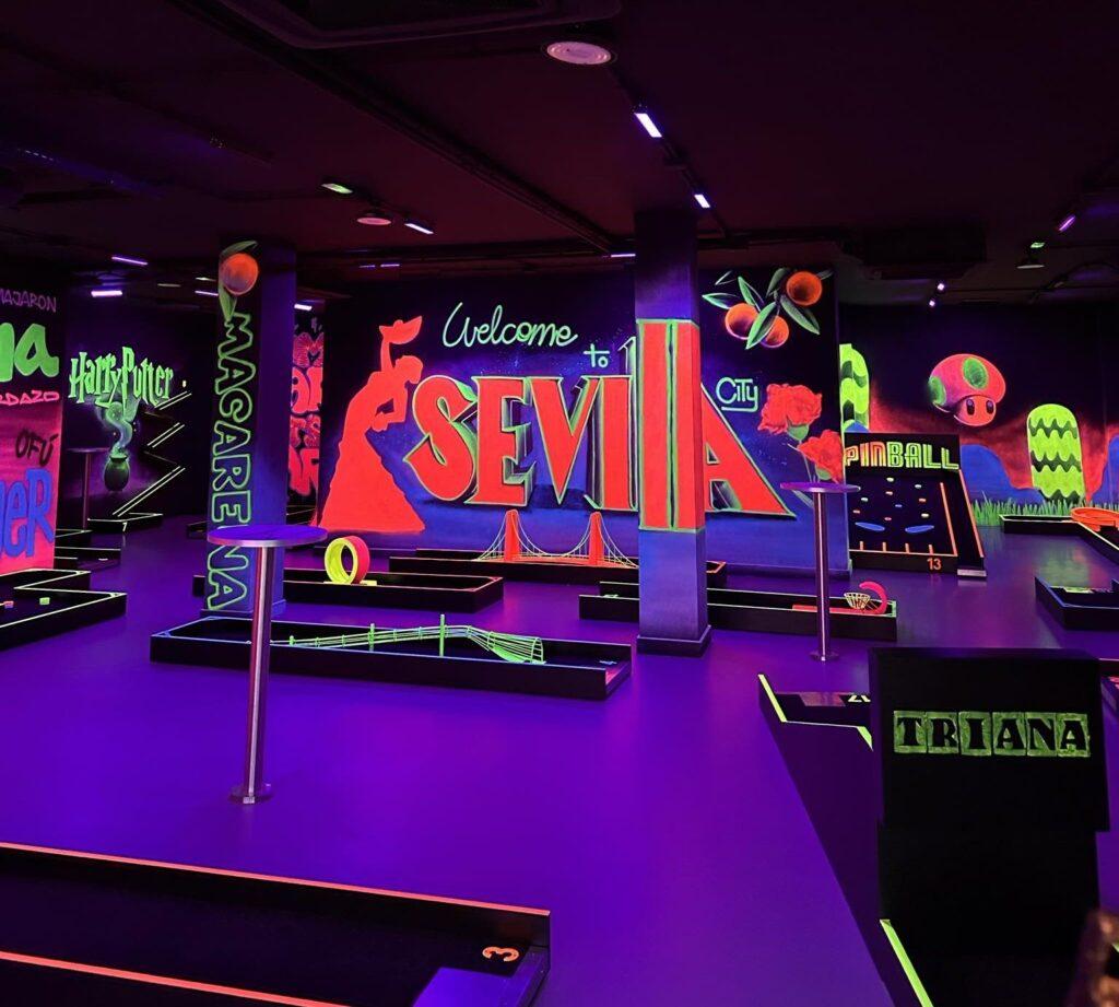 indoor neon mini golf course - pink "Sevilla" on wall