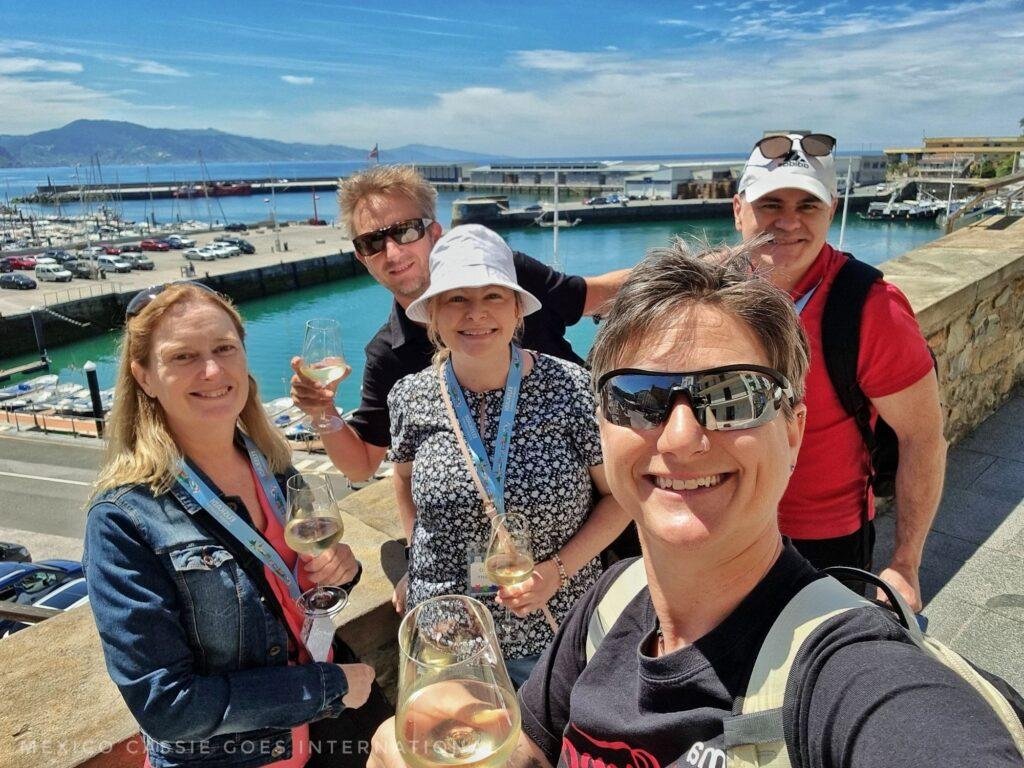 Cassie and 4 others drinking txakoli sparkling wine in the sun