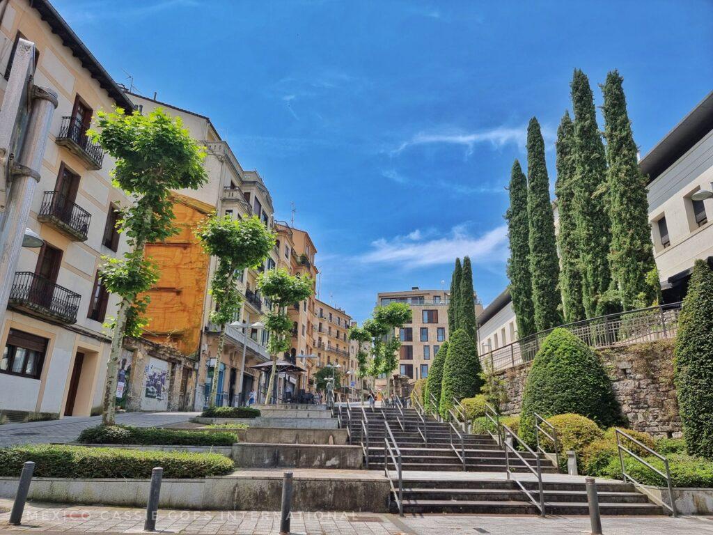 summer day view of aa quiet stretch of town, blue sky, trees, buildings