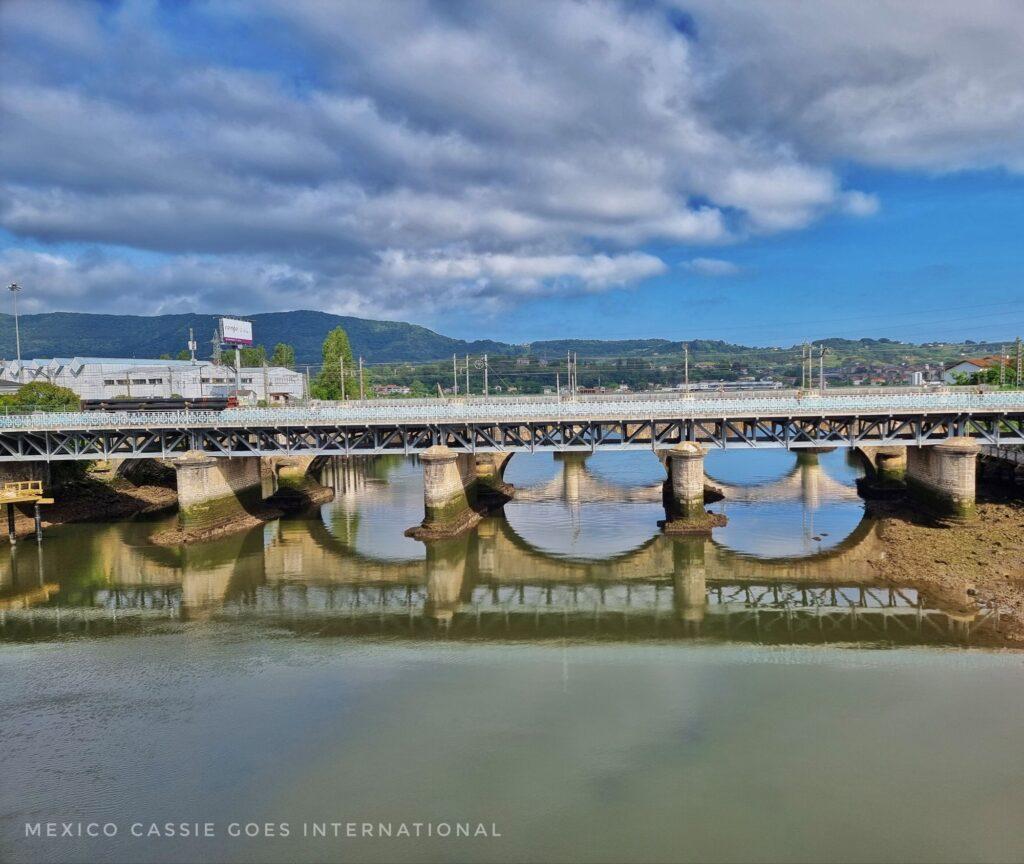 bridge over river and the reflection of its 3 arches in the water