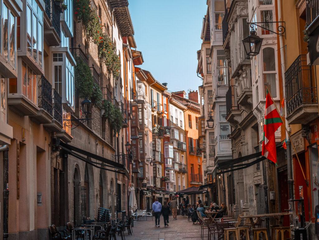 view of an old city street with tall buildings on either side