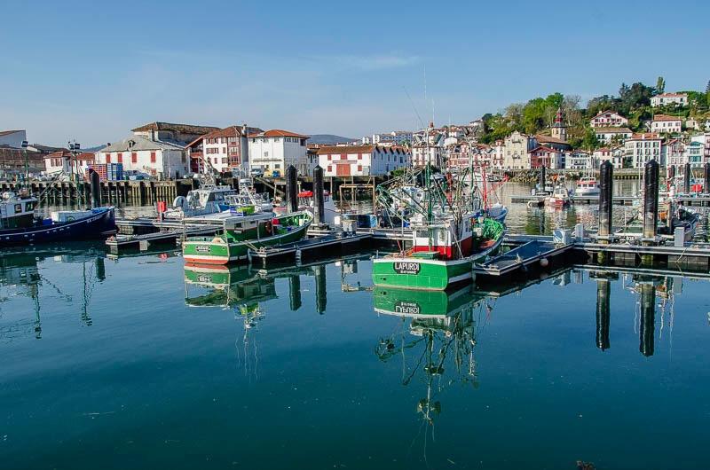 calm water with boats in quay