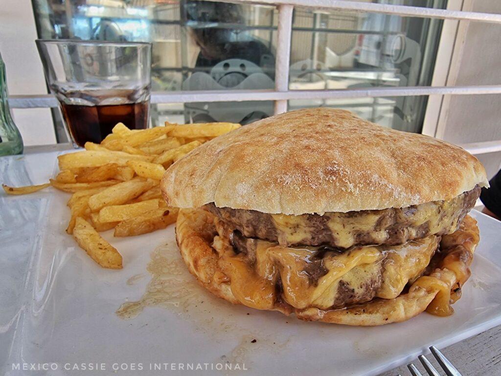 good looking double hamburger with cheese and fries on the side