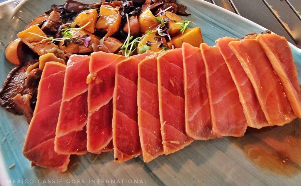 tuna sashimi on a plate with mushrooms