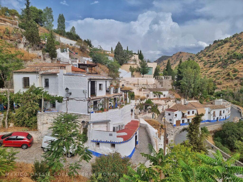 view of white houses on a bend in a hill