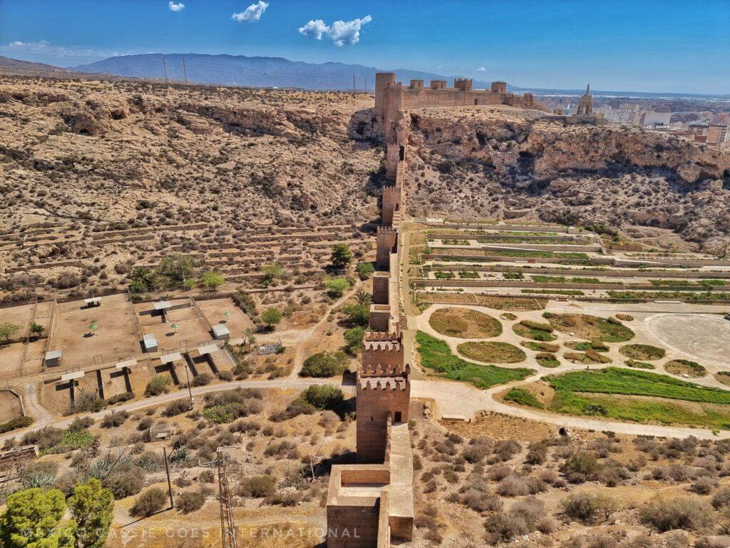 View from the Alcazaba of a long fortified wall and the land on either side