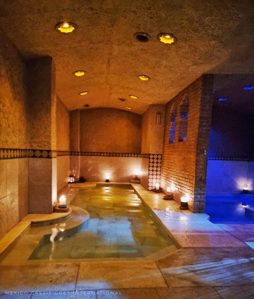 small, peaceful spa pool with no one in it. , gentle lighting