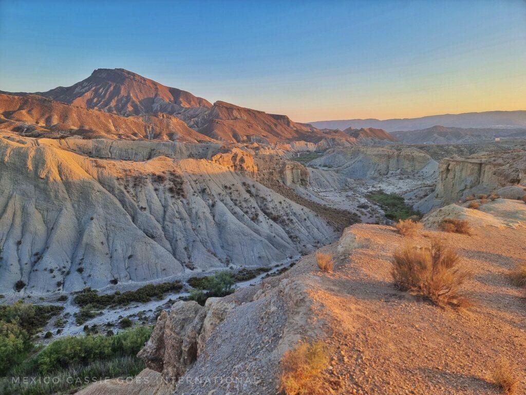 view over a valley in the desert at dusk