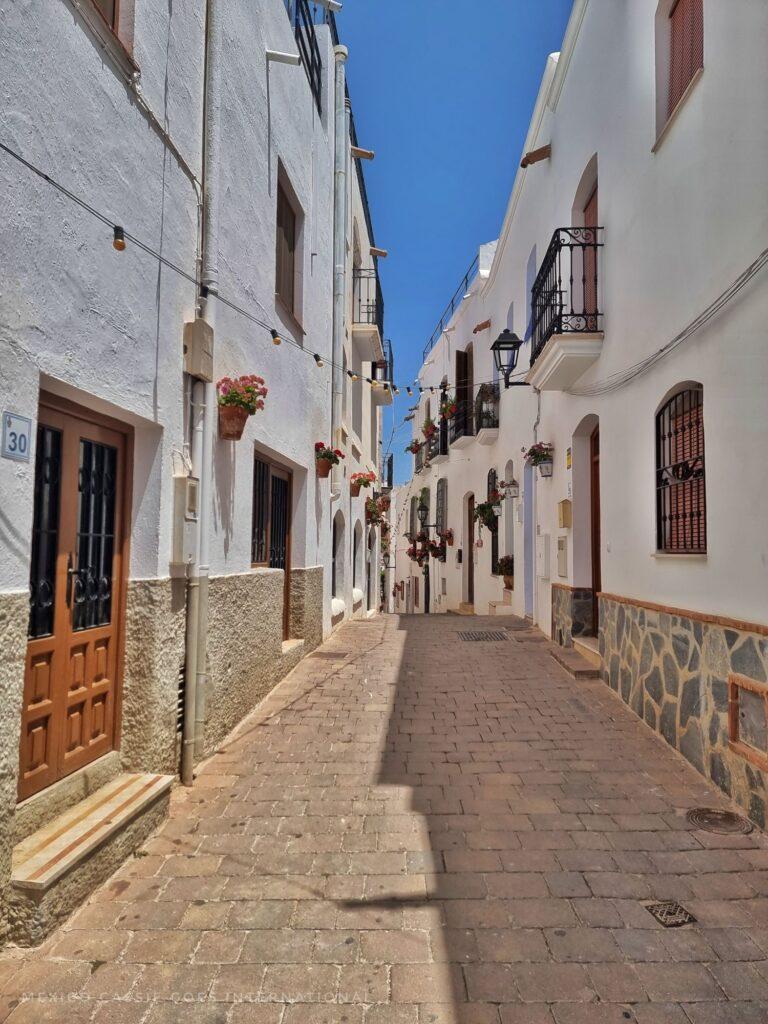 narrow street, white washed houses on either side