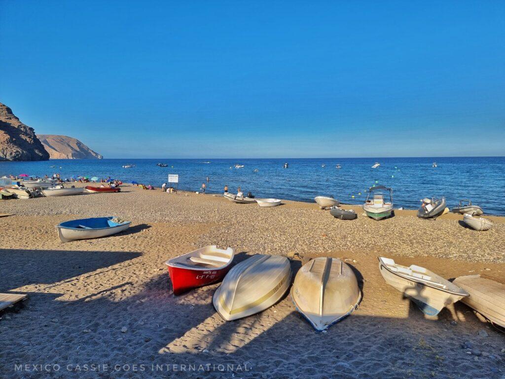 las negras beach, small boats lying upside down on sand, blue sea