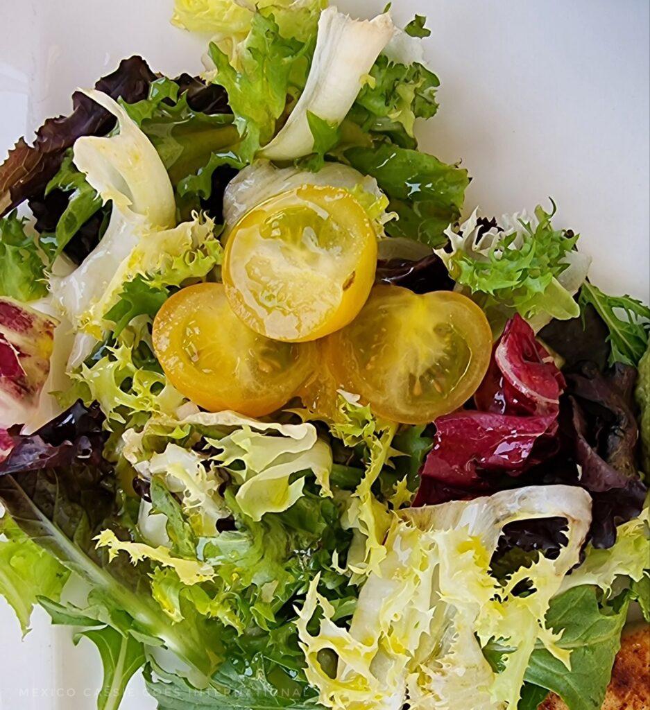 mixed lettuce with some cut up cherry tomatoes