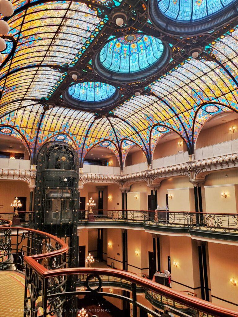 view of the inside of Mexico City's Gran Hotel - indoor balconies and incredible glass ceiling