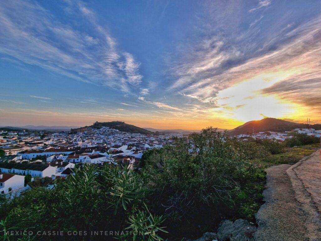 sunset view over Aracena - white houses, castle on hill