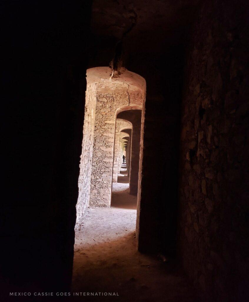 series of door frames in dark space - only light is the doors