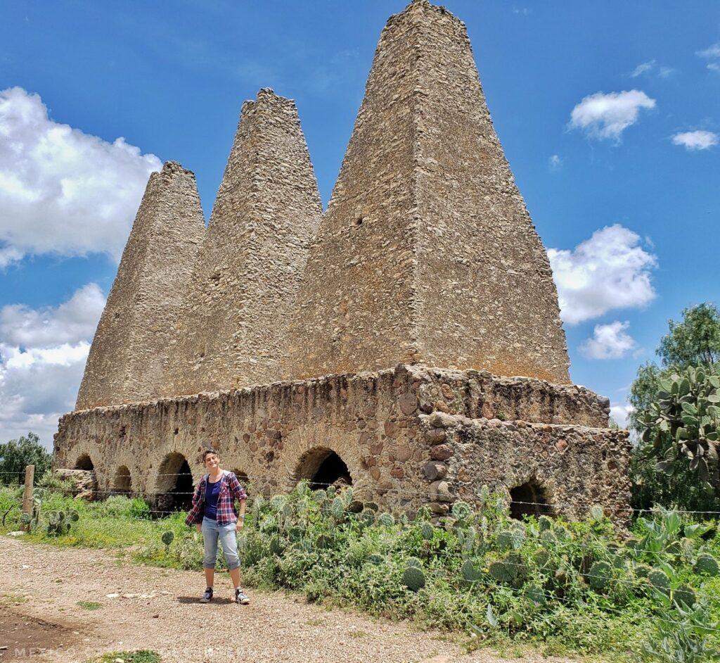 Cassie standing in front of the 3 hornos - chimneys 