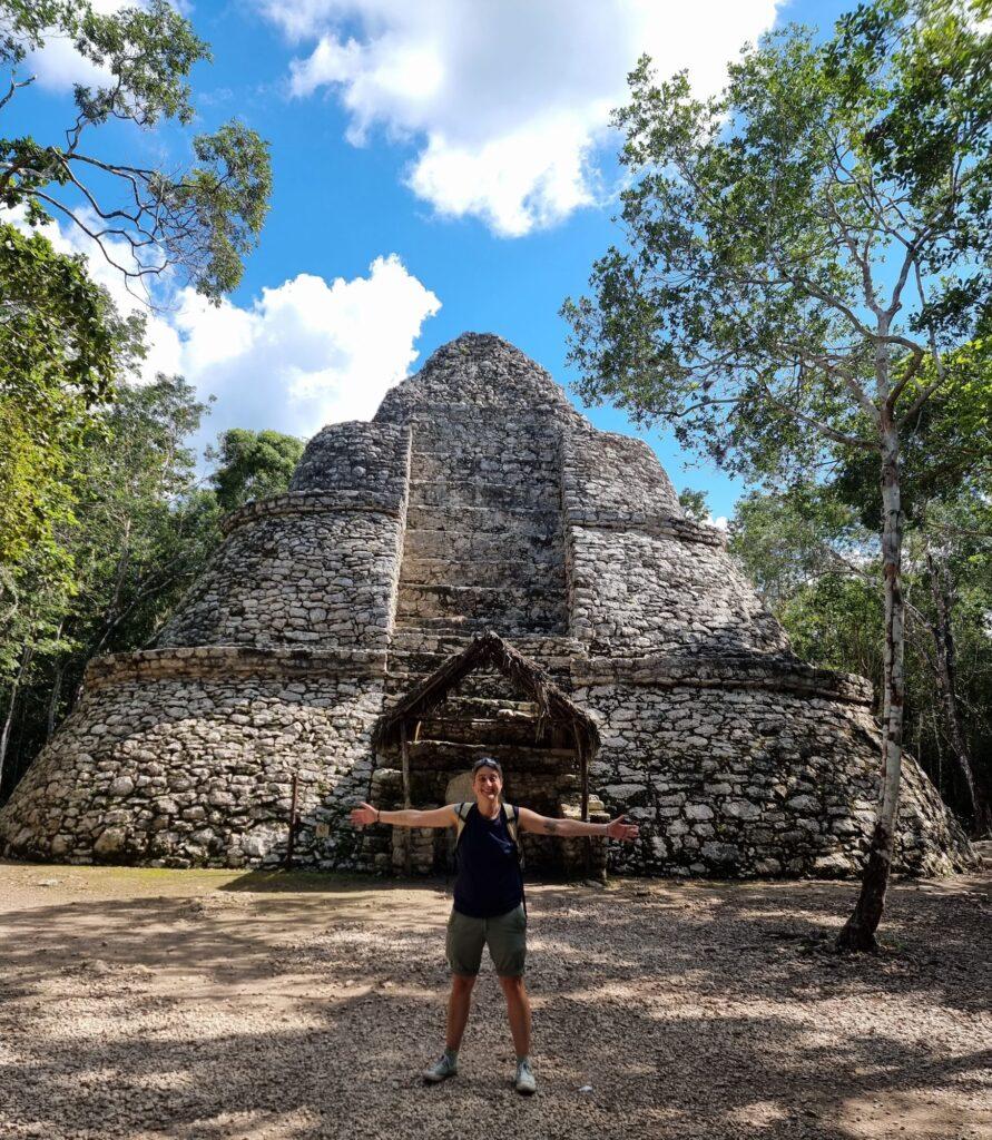 Cassie standing in front of the treasury, a pyramid in the jungle at Coba