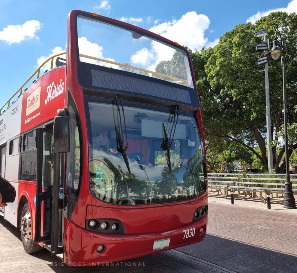 red double decker open top tourist bus