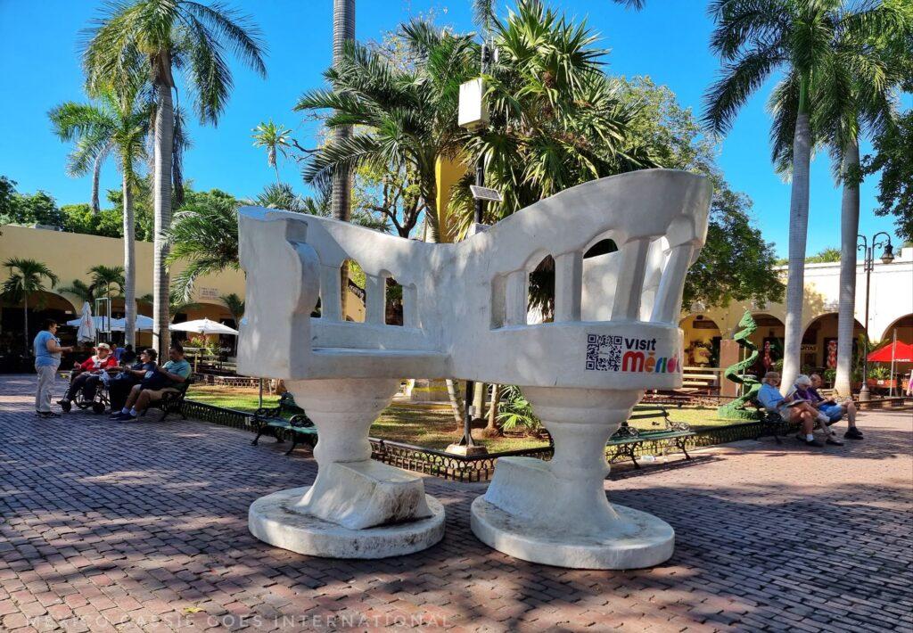 giant white double chairs on a plaza