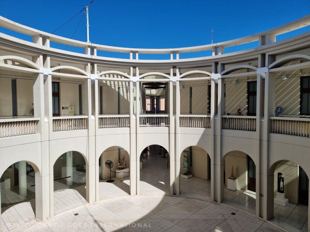 rounded courtyard with white arches - 2 stories, blue sky