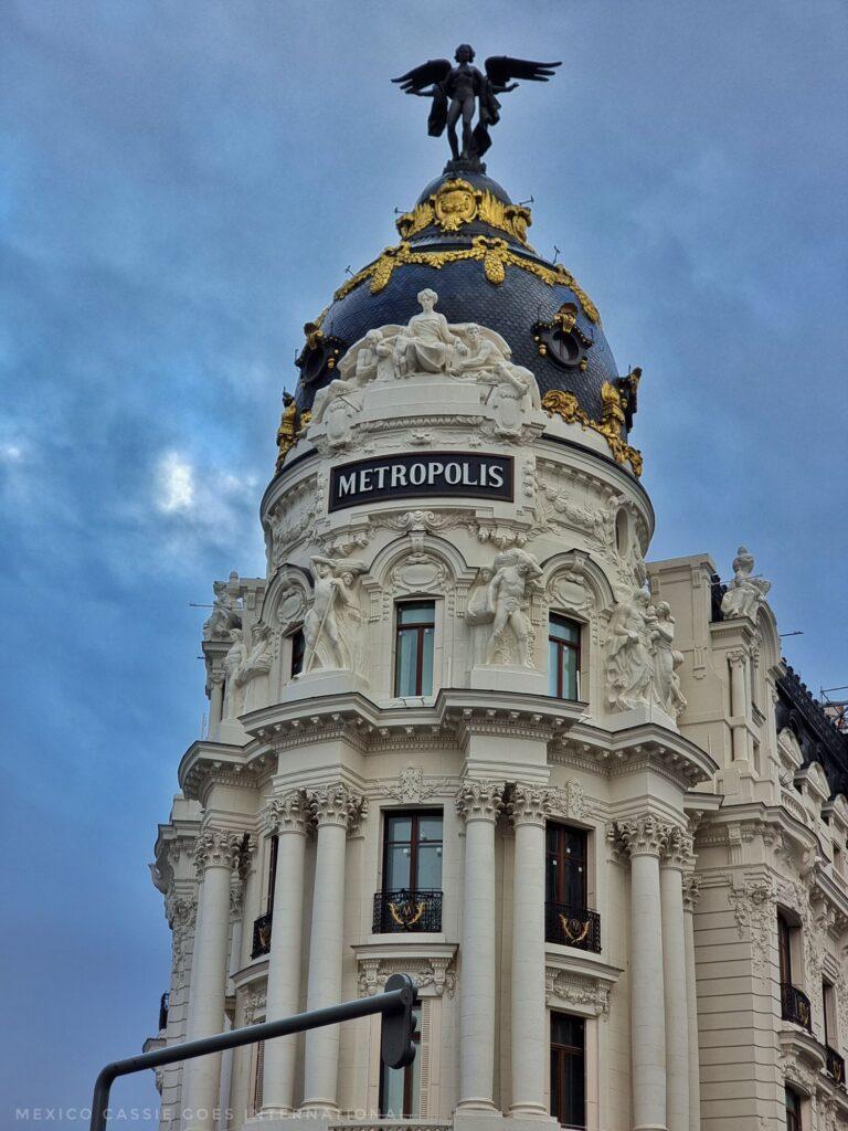 close up of the Metropolis building in Madrid - white building with grey & gold dome