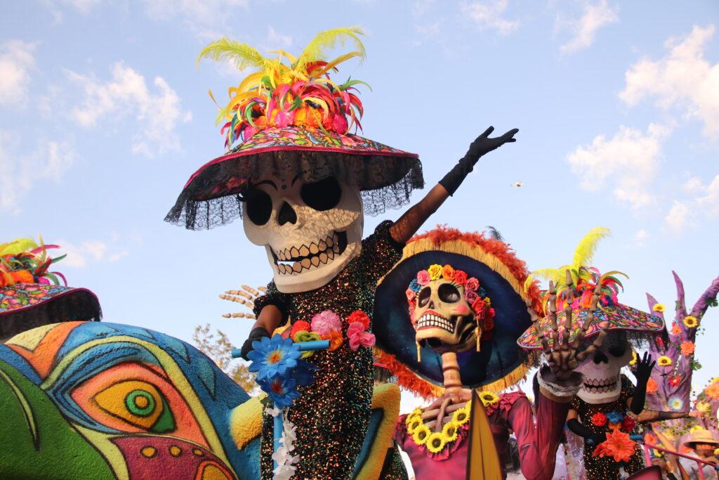 oversized skeletons in hats and clothes on a parade