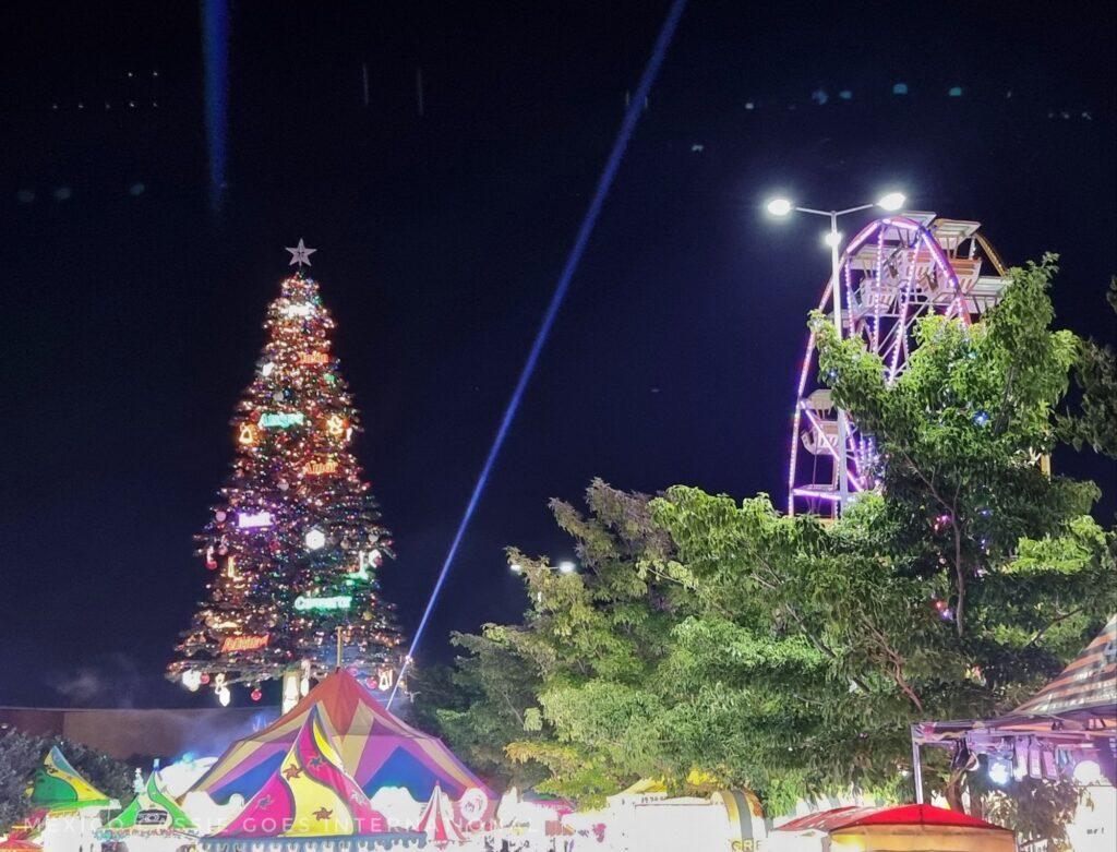 Enormous Christmas tree with fairground rides around it