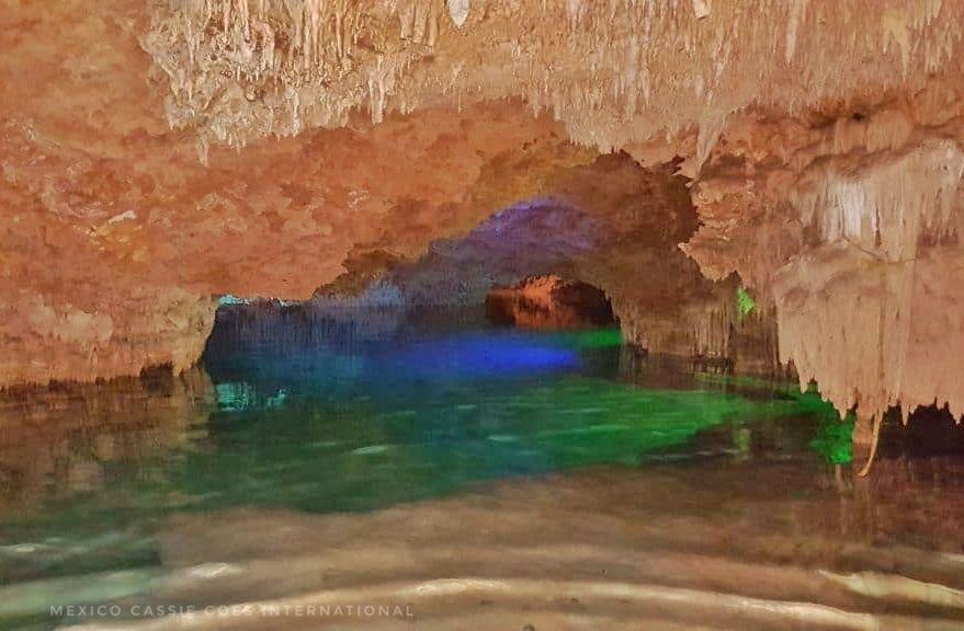 empty cave cenote with green water, nicely lit