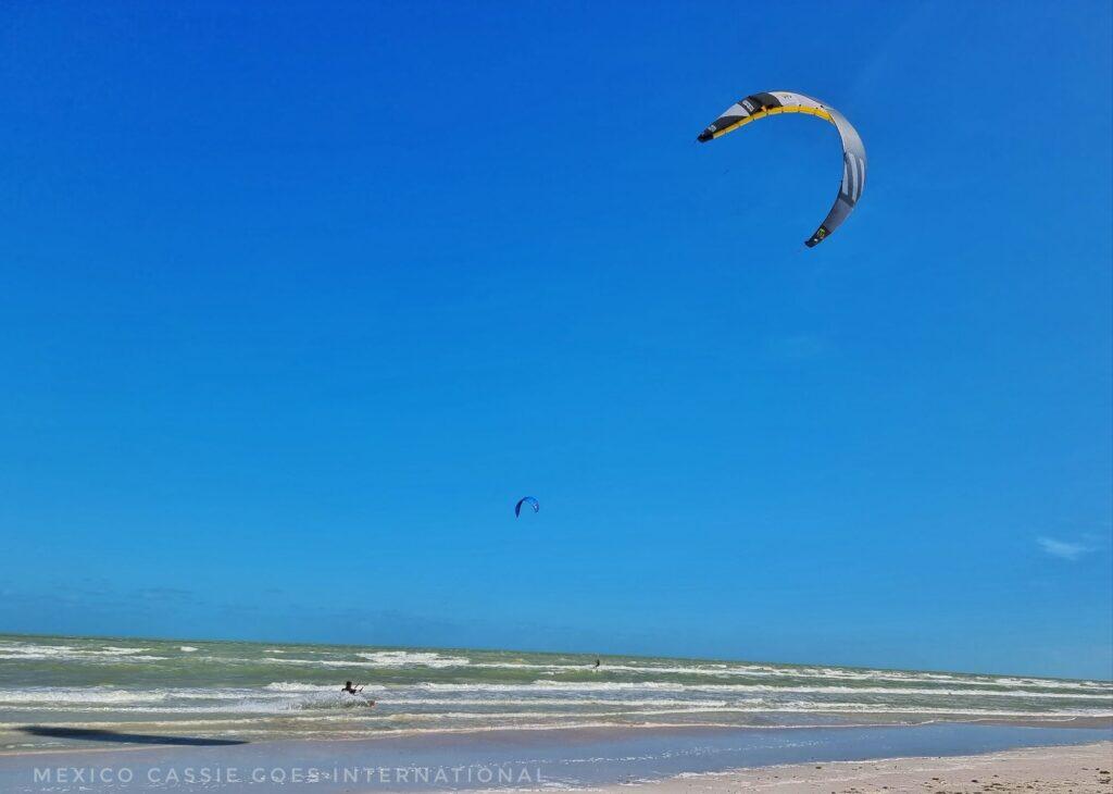 blue sky, people kite surfing