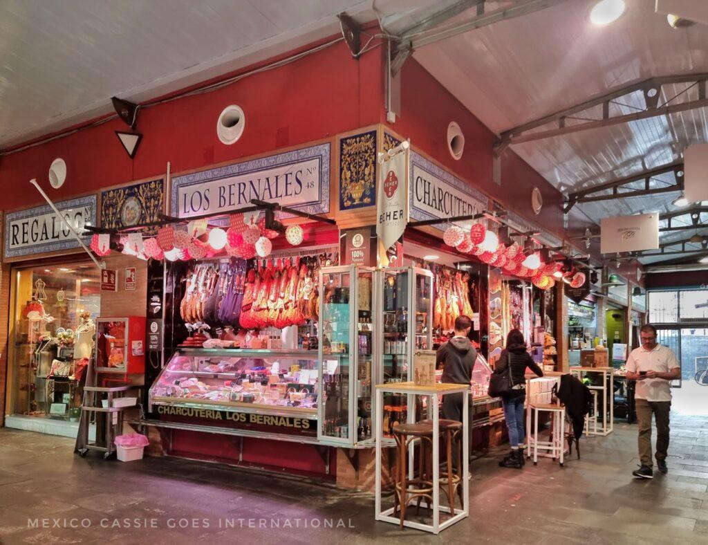 market store in Triana selling hams, cafe stools and tables