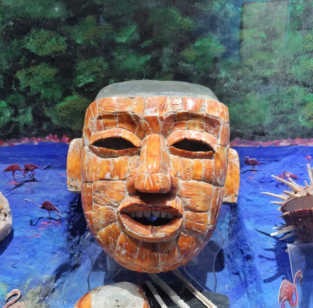 orange jade mask on blue and green background