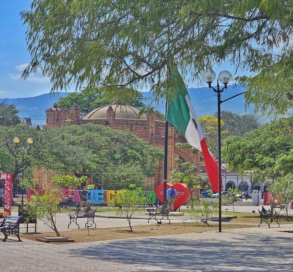 Chiapa de Corzo main plaza - you can see the fuente building, the chiapa de corzo letters, a mexican flag and trees