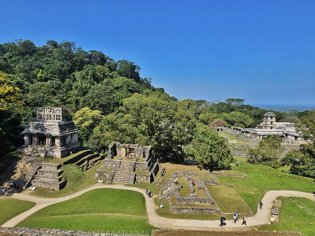 view over palenque ruins from above, blue sky, green grass and trees