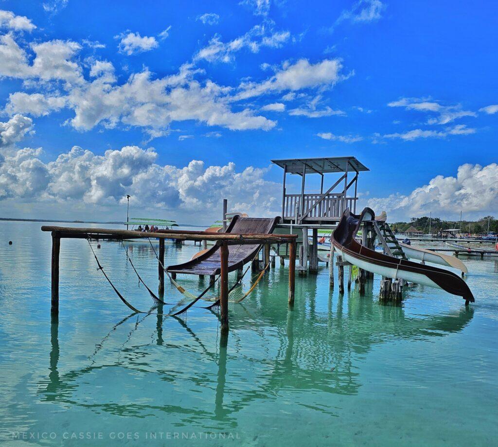 hammocks in water, slides into water, blue sky