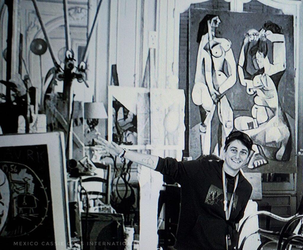 black and white photo of Cassie surrounded by picasso memorabilia