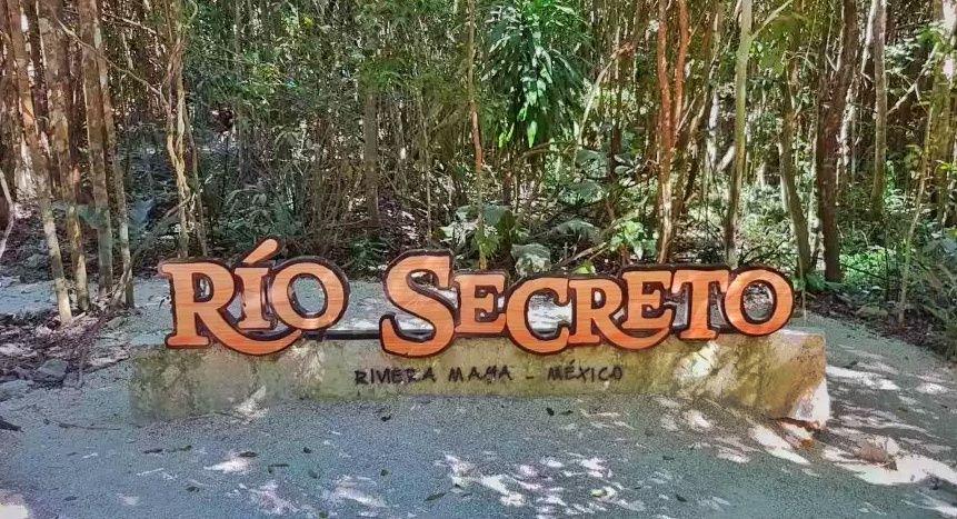 Río Secreto written in wooden letters in front of jungle