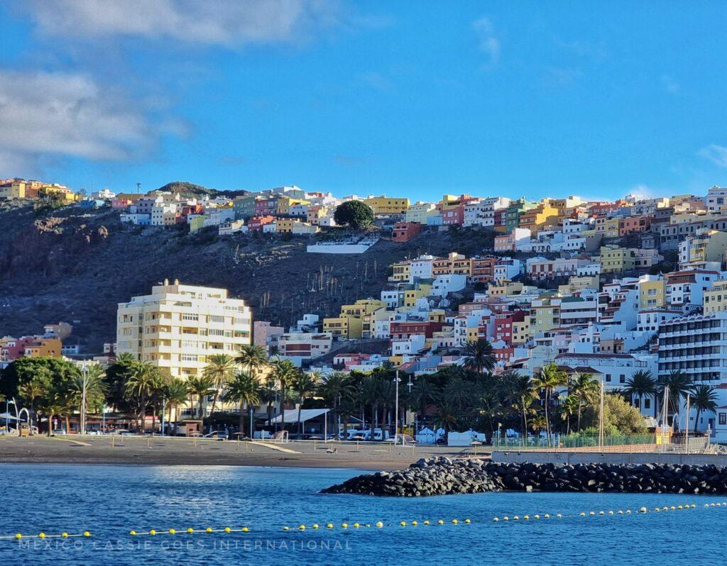 view of san sebastian de la gomera from the water - water, beach, houses going up hill side