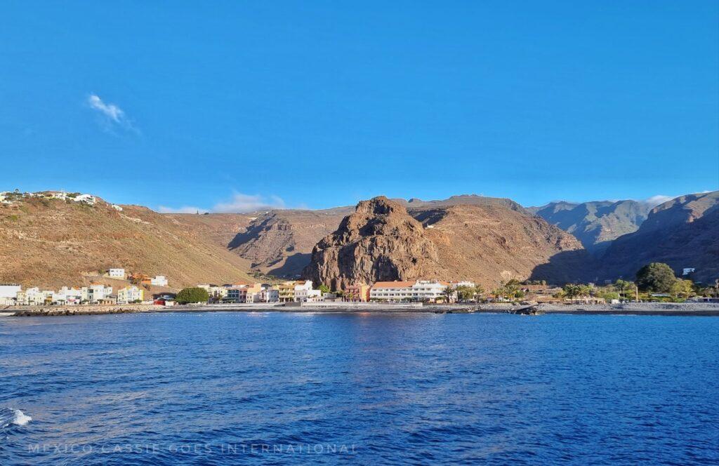 playa santiago from the water - water, small town, cliffs behind
