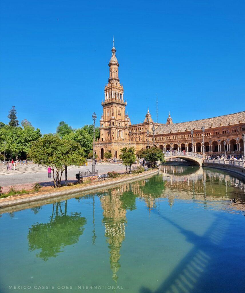 tower at the plaza de españa on a sunny day - reflected in the water