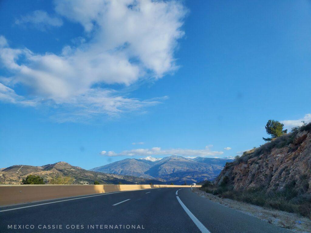 empty road, blue sky, mountains in front