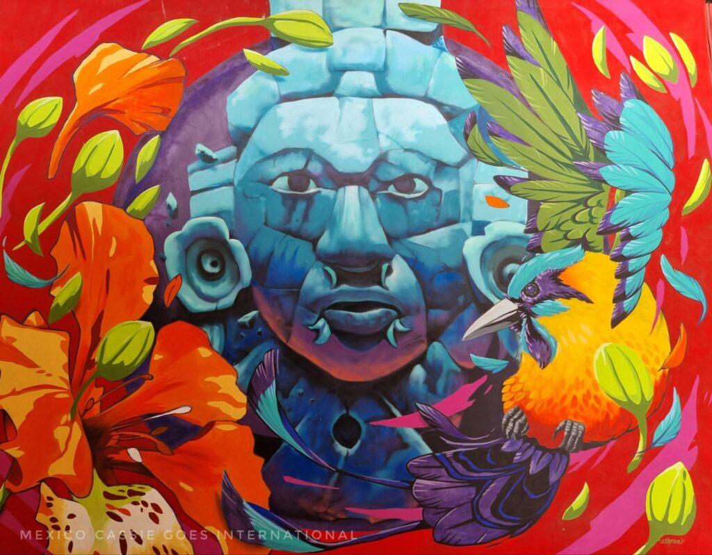 traditional Mexican sculpted face of a god as a mural