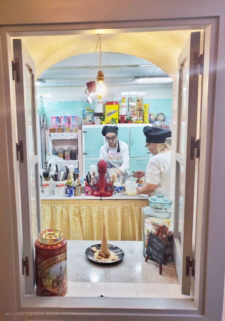chefs preparing desserts - photo taken through an internal window