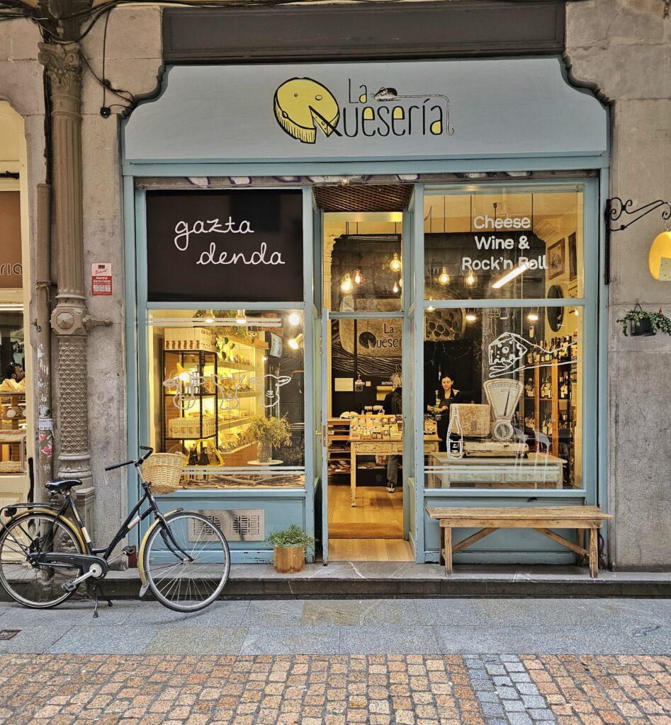 cheese shop with bike on left leaning against the wall