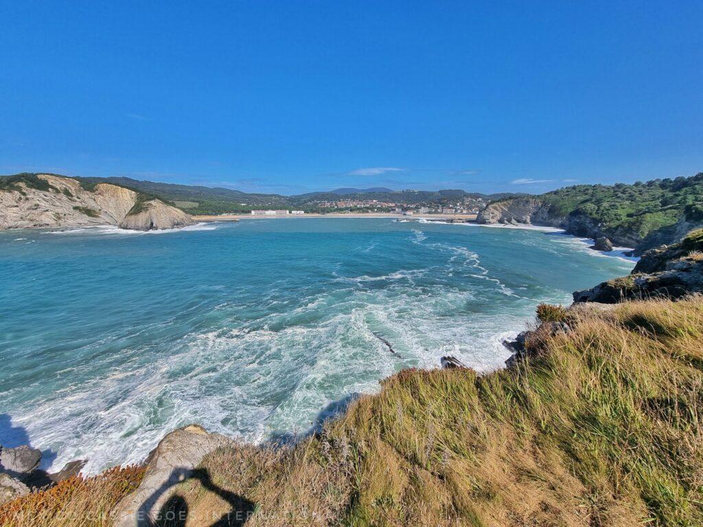 view over the whole bay of Plentzia from cliff top beautiful blue water, green cliffs, blue sky